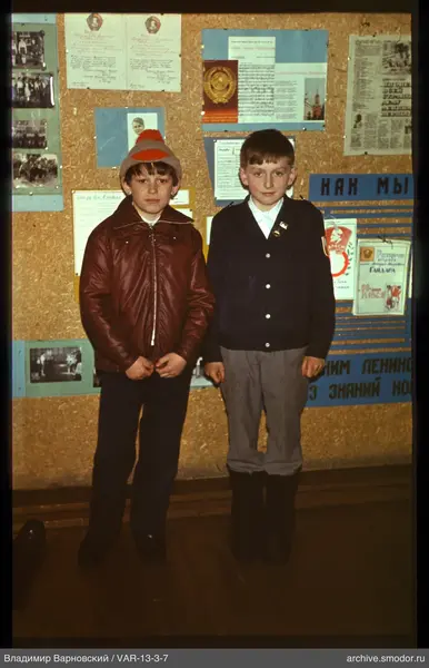 Two boys in front of an information board
