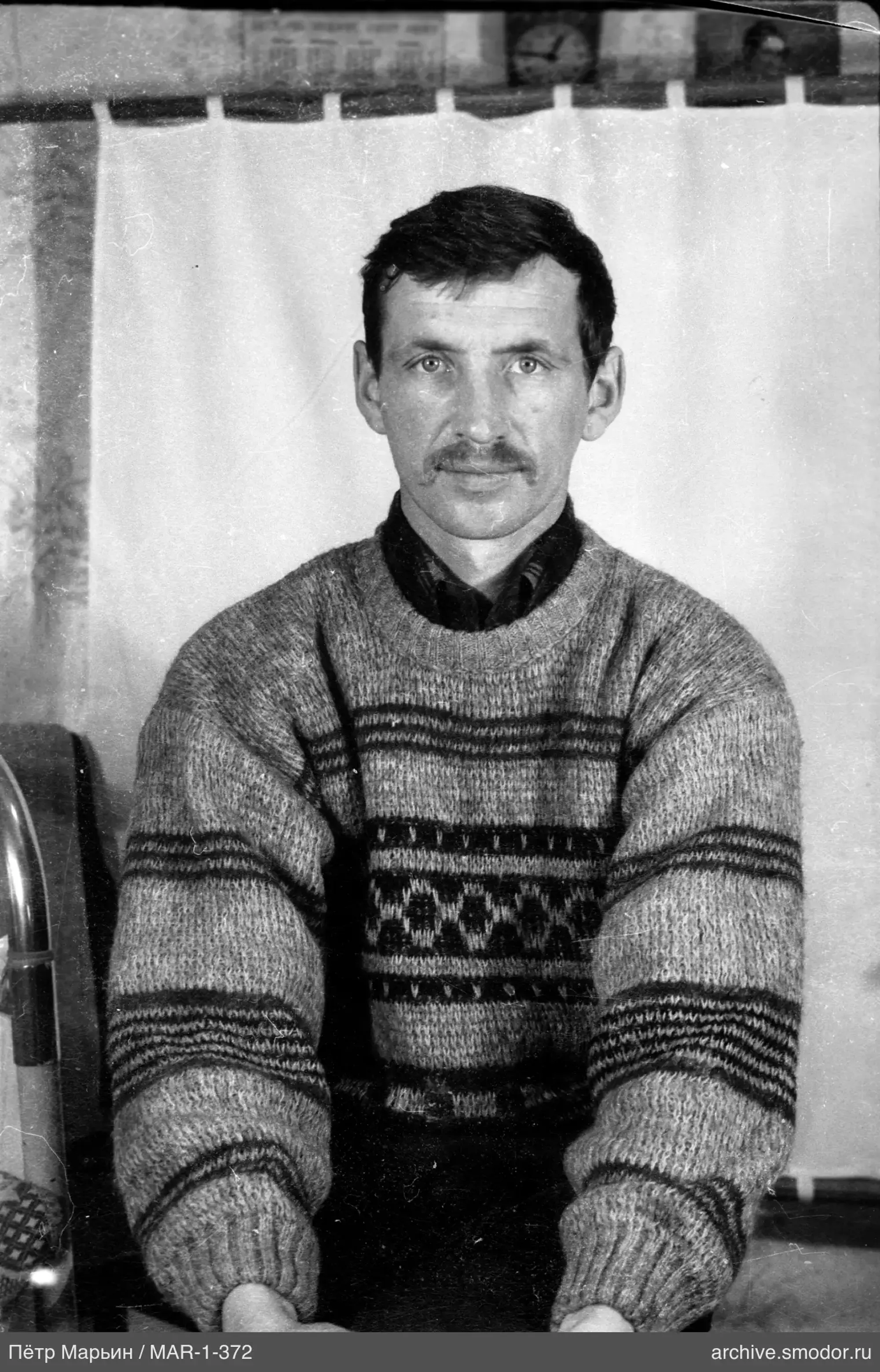 Portrait of a man in a sweater and shirt