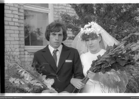 Portrait of a man and woman with bouquets of flowers