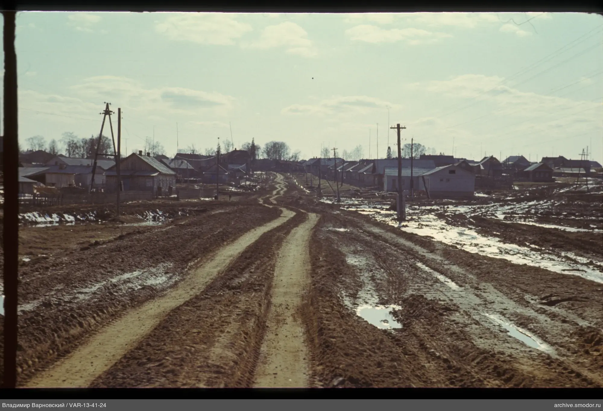 Village street with houses and power lines