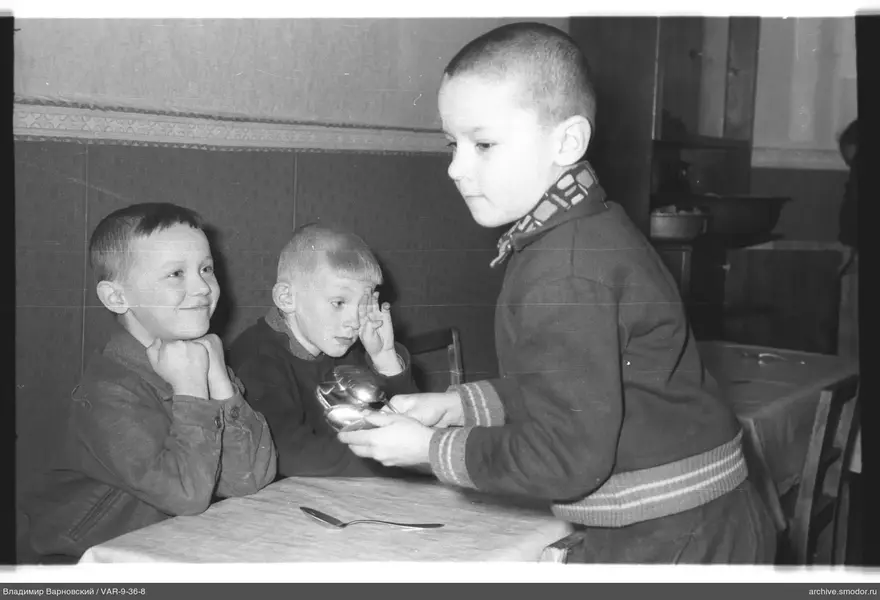 Three boys in a room with furniture