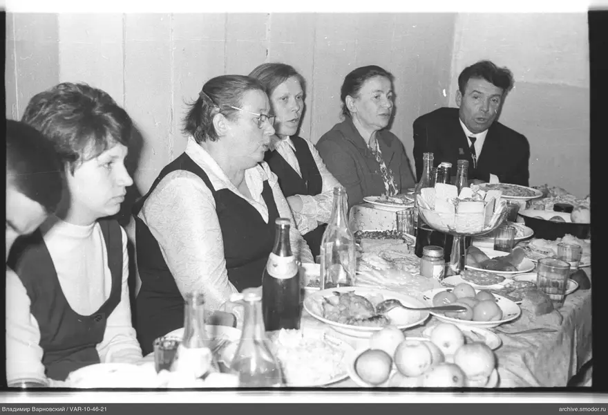 Group sitting at a table with food and drinks