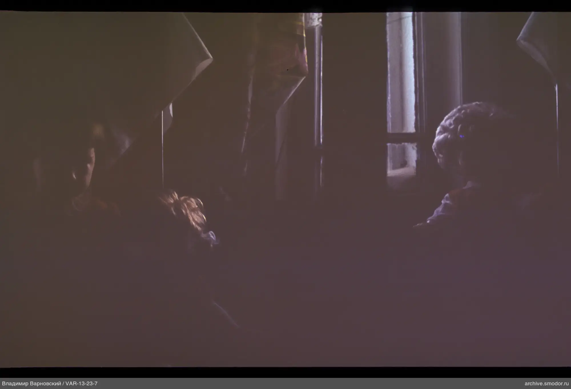 People indoors with patterned fabric and window