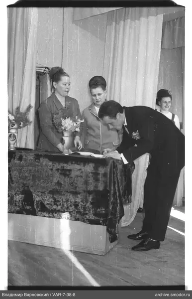 Man signing a document at the table