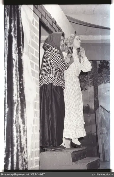 Three women on steps by a wall