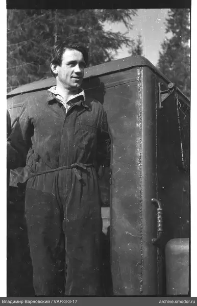 Man next to a metal structure
