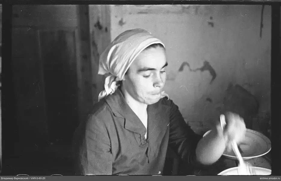 Woman with spoon at the table