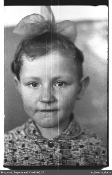 Child portrait with bow and knitted sweater