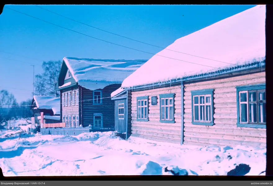 Wooden houses with snowy roofs