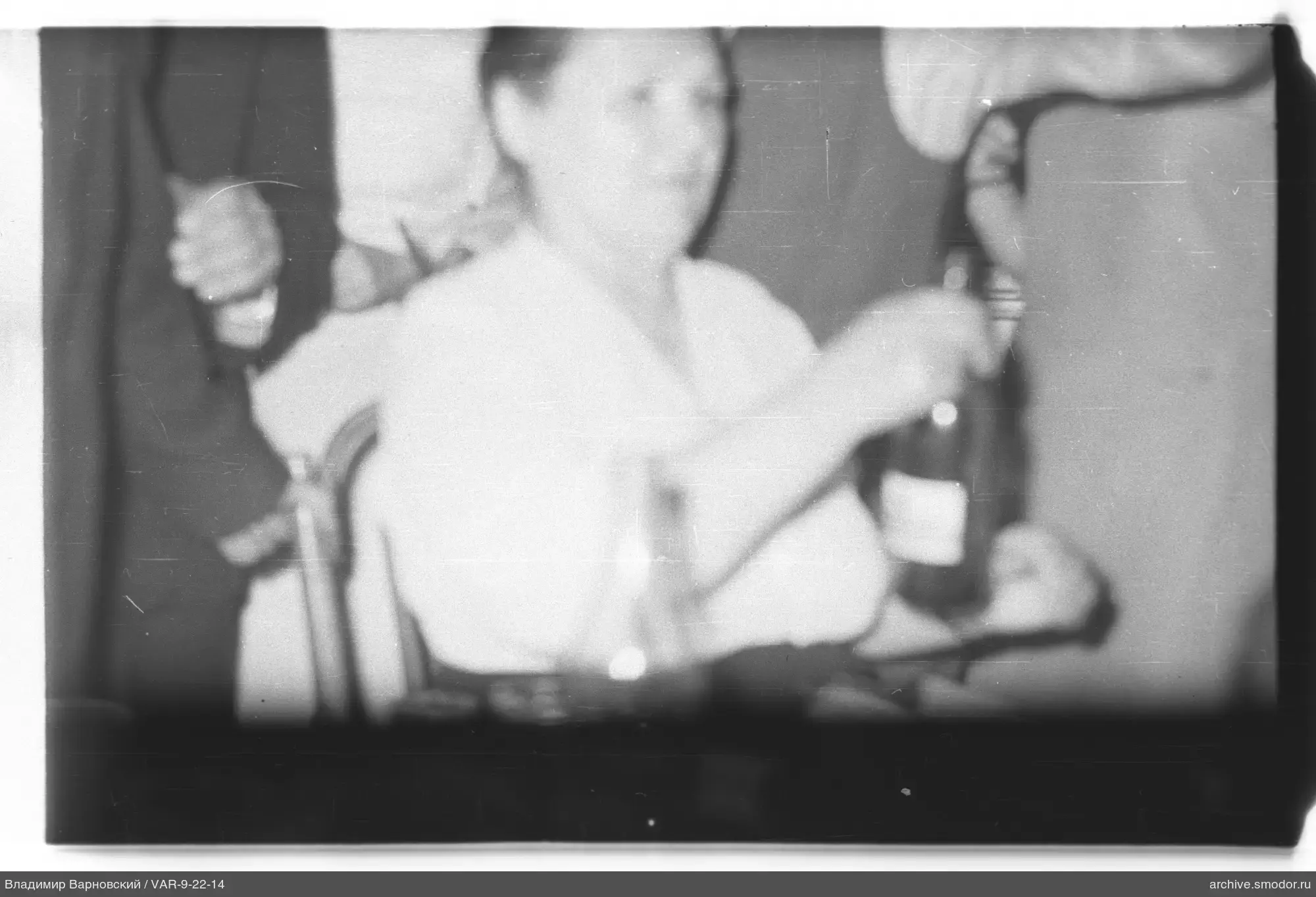Frau mit Flasche am Tisch