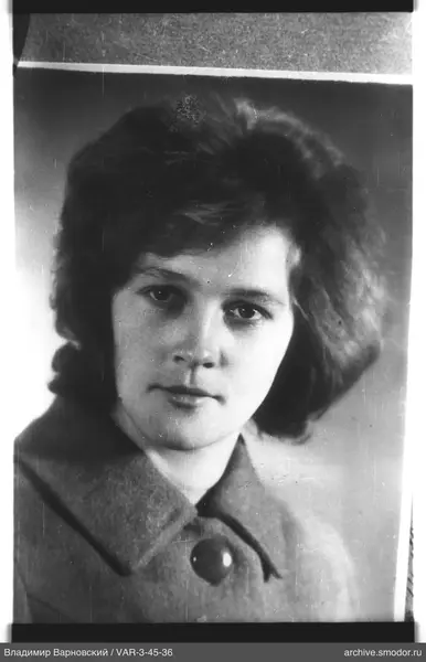 Portrait of a woman in a coat with a large button