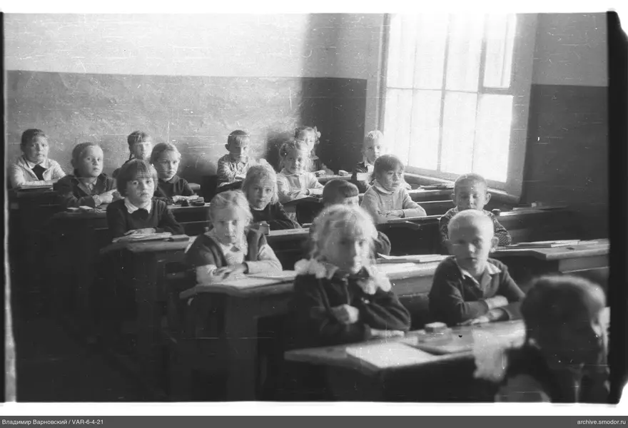 Kinder an Tischen im Klassenzimmer