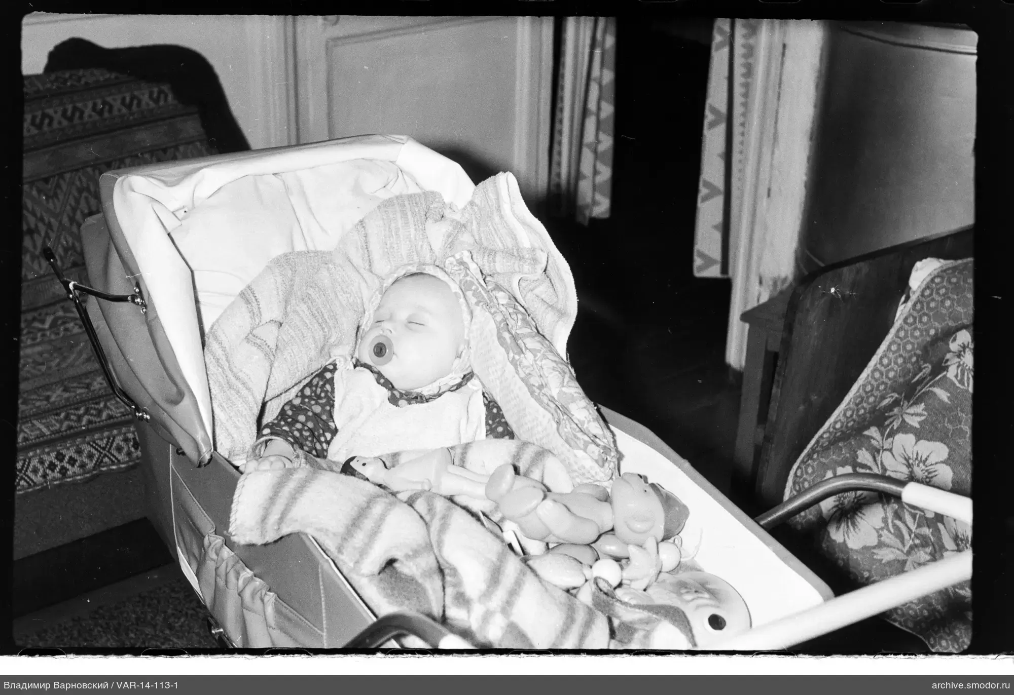 Child in stroller with toys