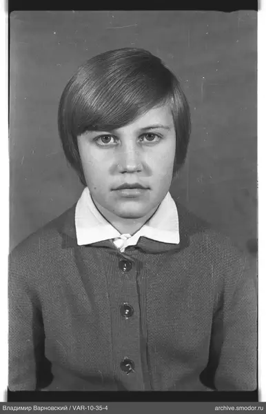 Portrait of a girl in a light shirt and cardigan