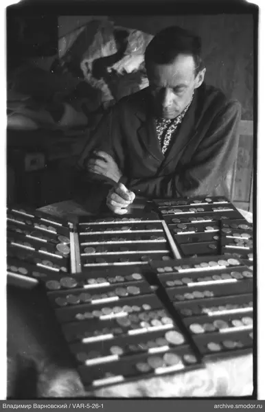 Man with coins at the table