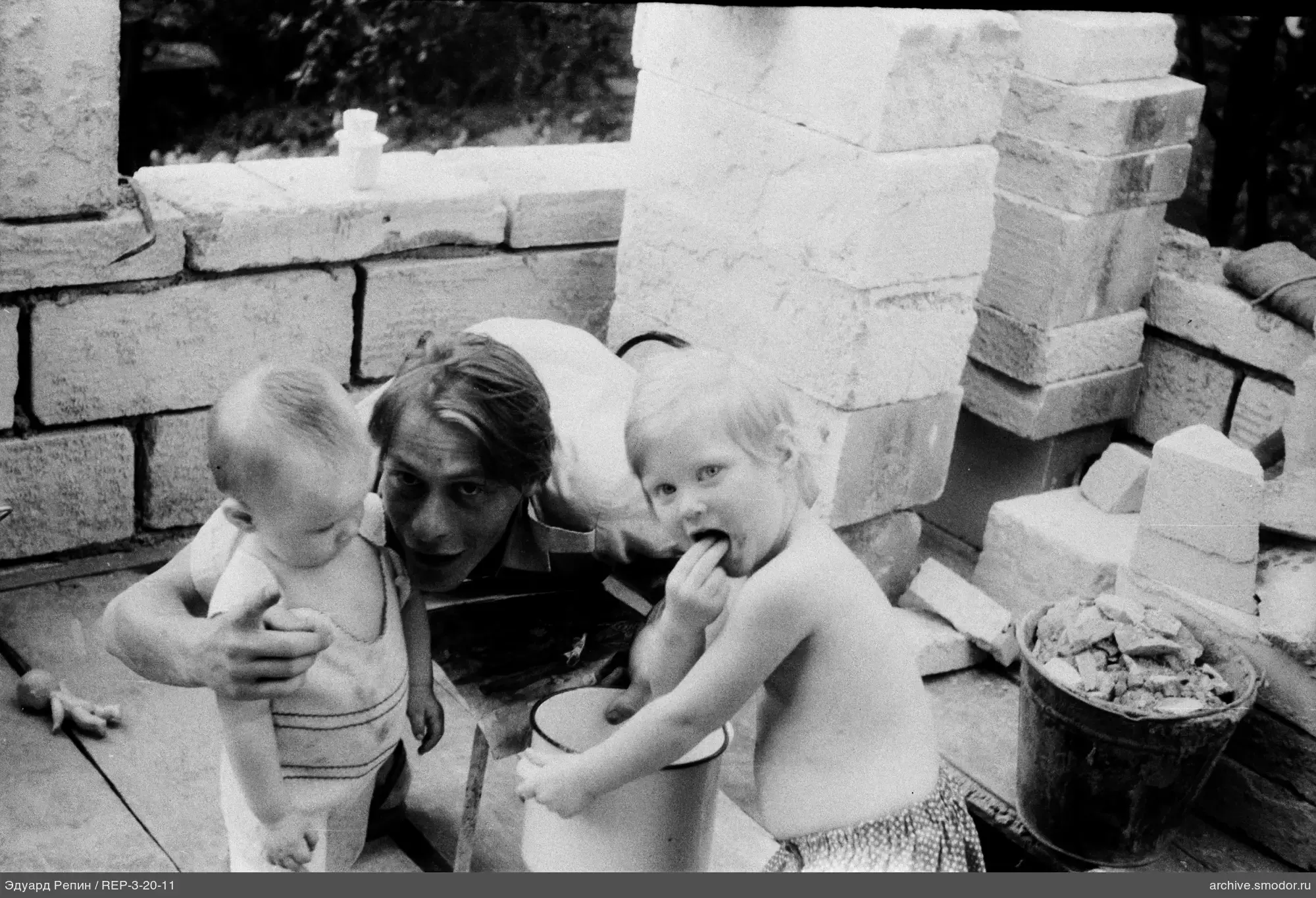 Man with two children at construction site