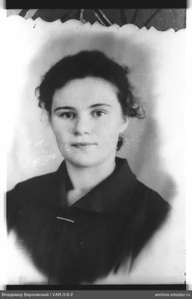 Portrait of a woman with dark curly hair