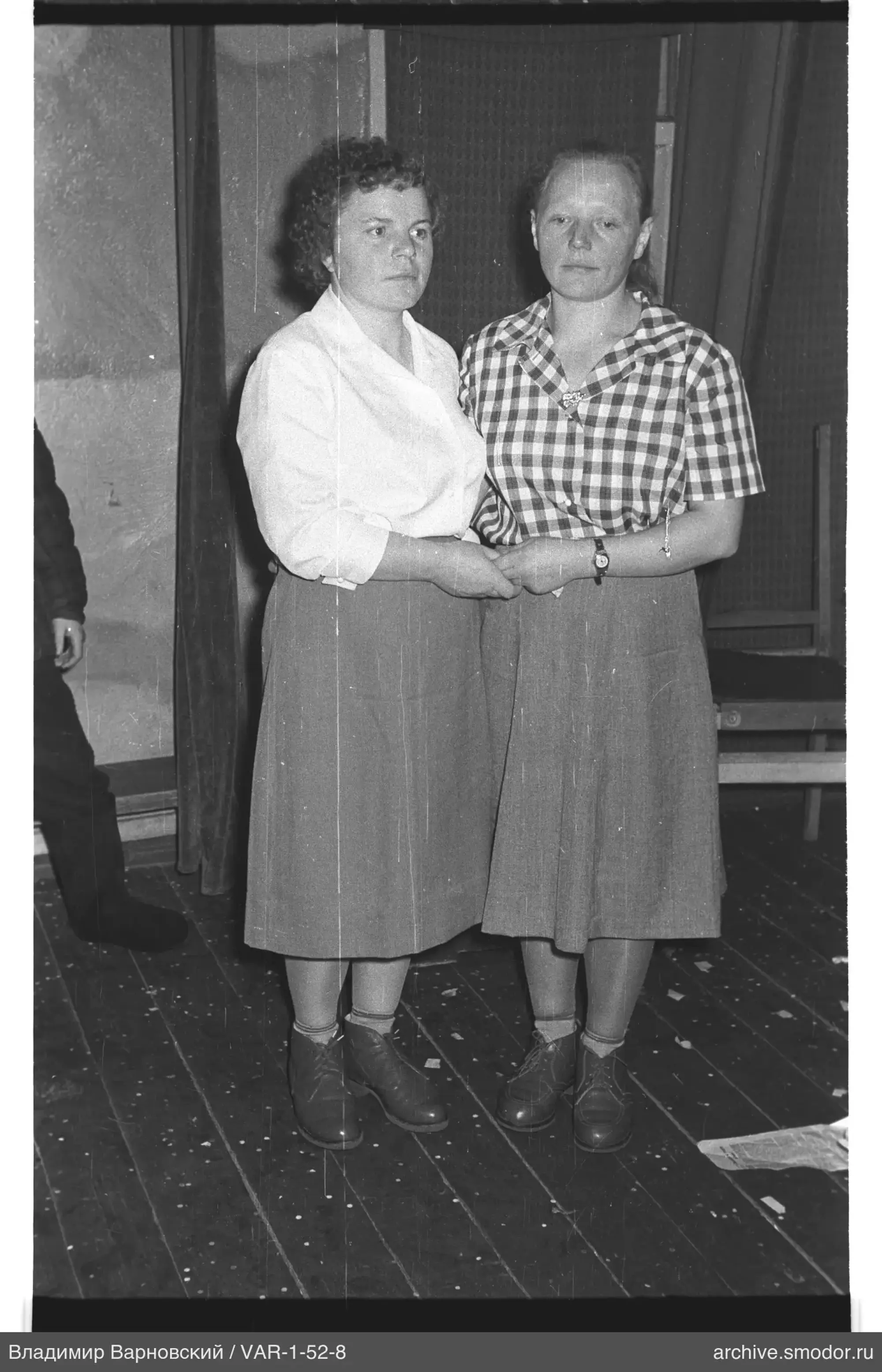 Two women holding hands