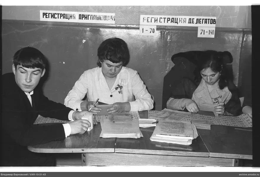 Three people at a table with documents