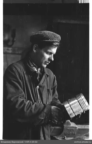 Profile portrait of a man holding a metal object