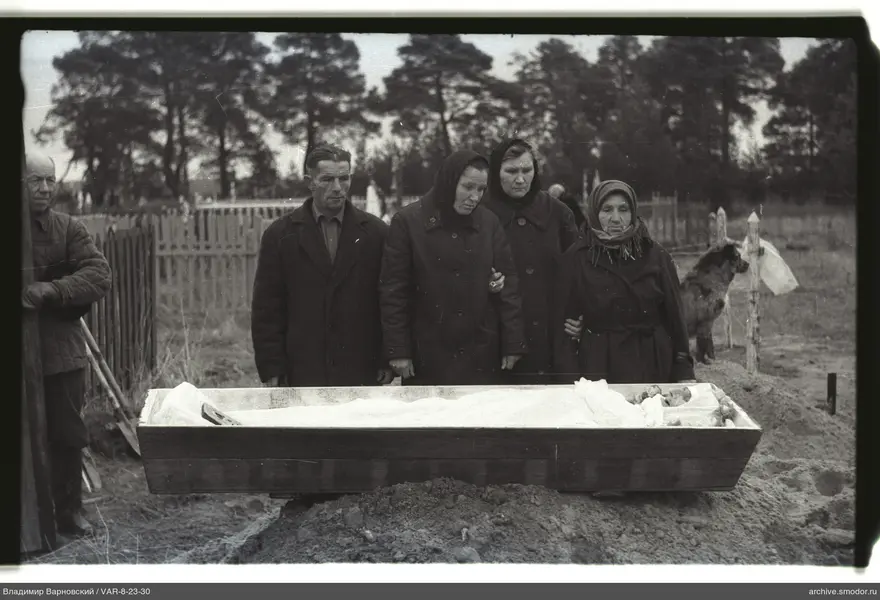 People by a wooden coffin
