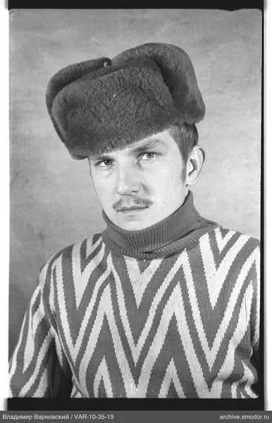 Portrait of a man in a sweater and fur hat