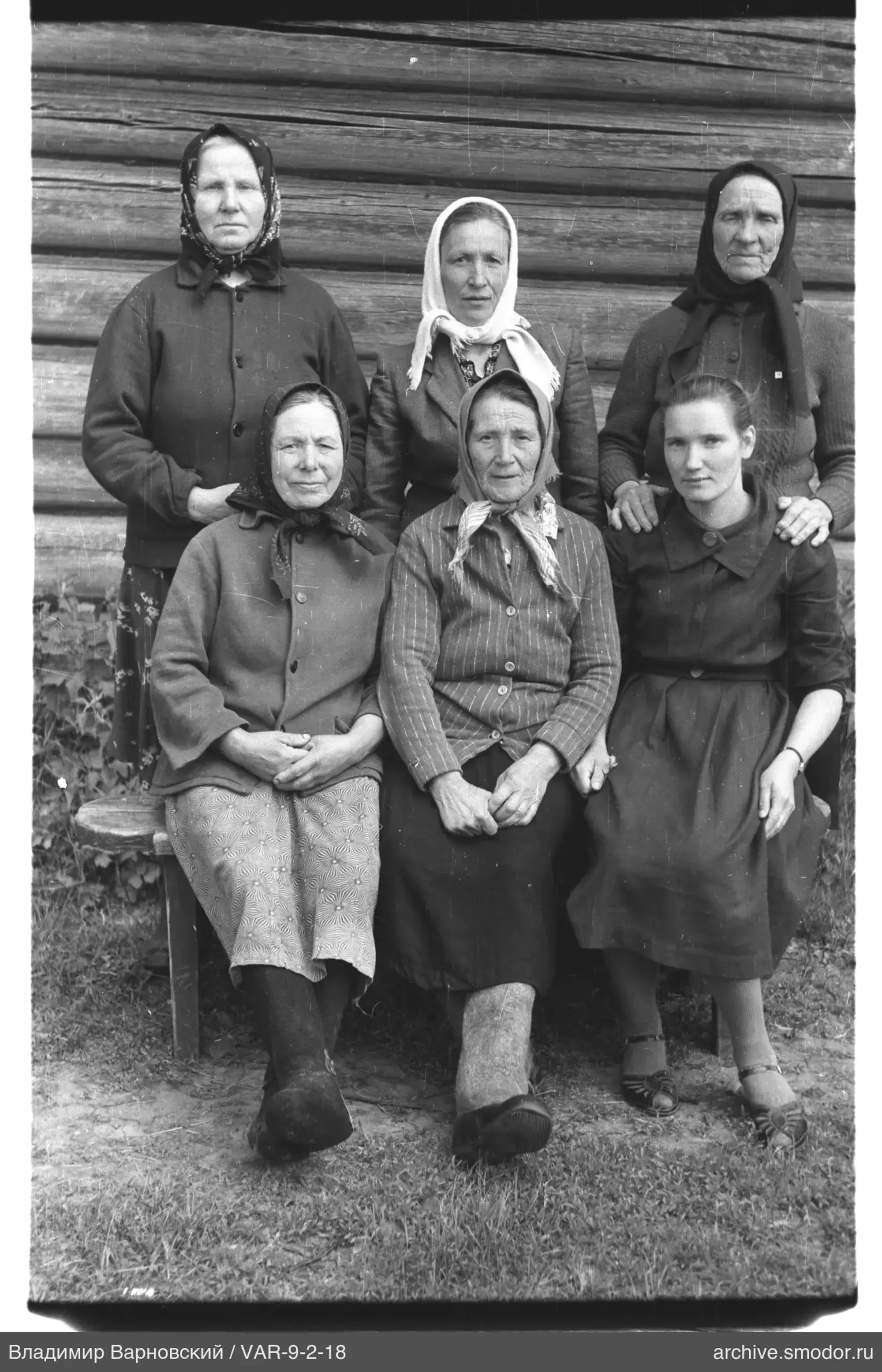 Gruppenporträt von Frauen vor einer Holzwand