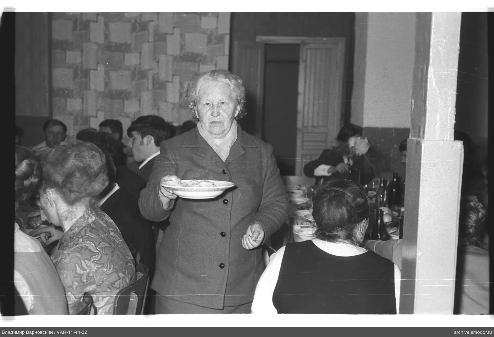 Elderly woman with plate at event