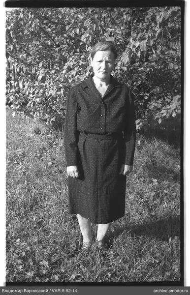 Frau in dunklem Kleid im Gras