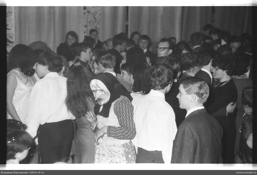 Gruppe von Menschen mit Maske und gemusterter Schürze