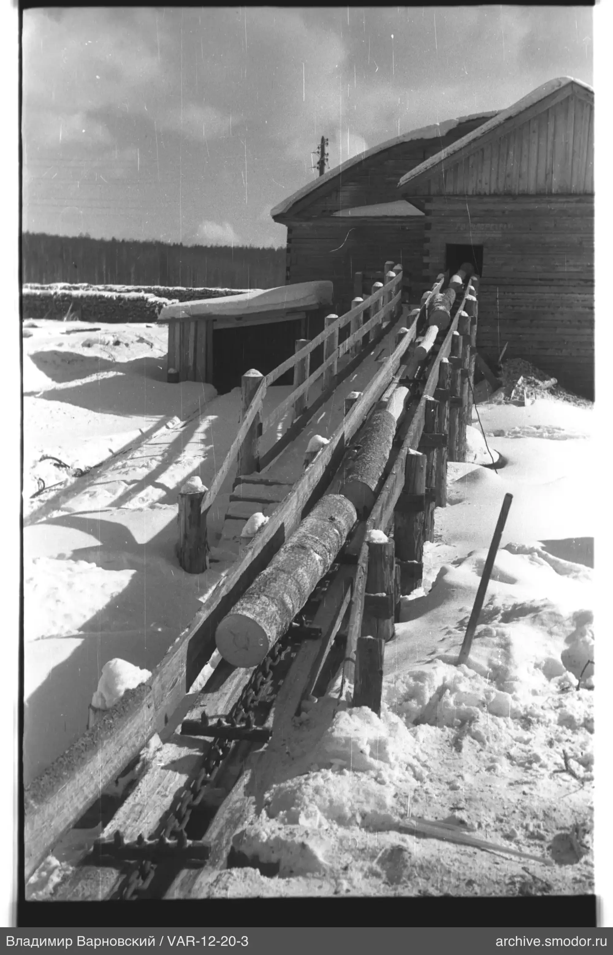 Wooden building with conveyor and snow