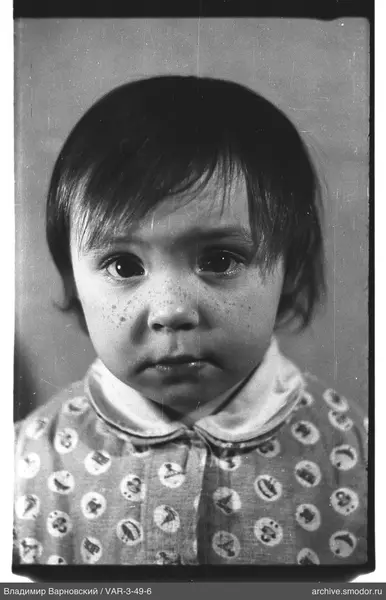 Close-up portrait of a child with freckles