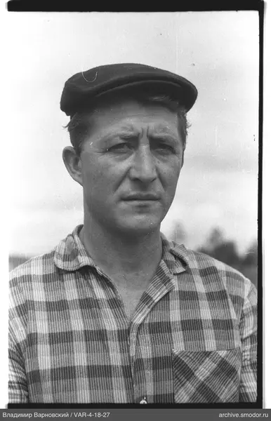 Portrait of a man in a cap and checkered shirt