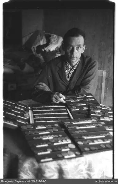 Man with coins at the table