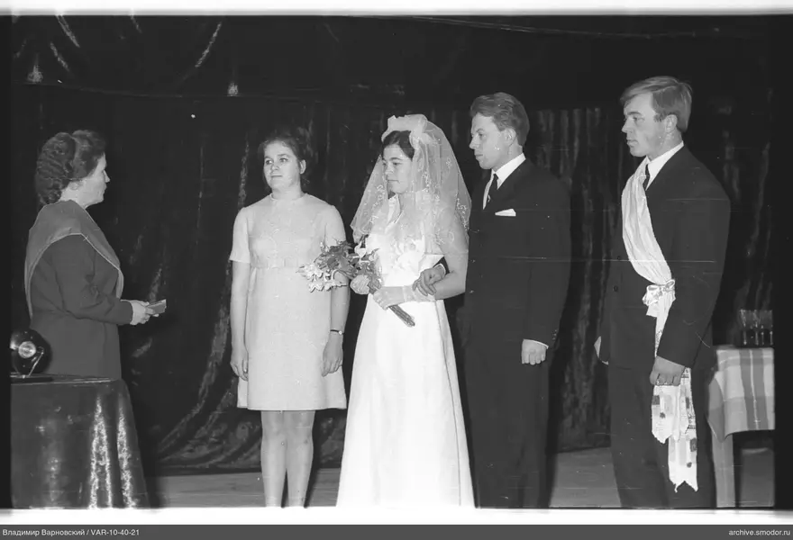 Group of people against a dark curtain