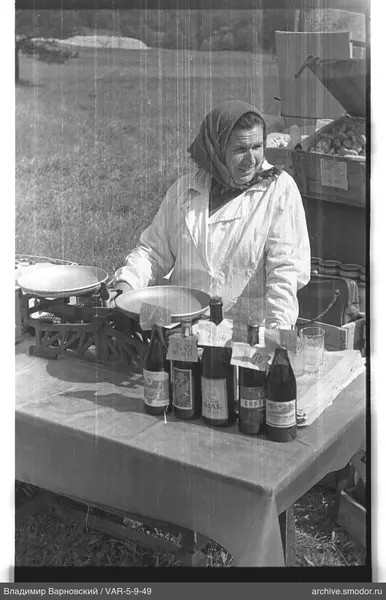 Woman at a table with bottles and scales