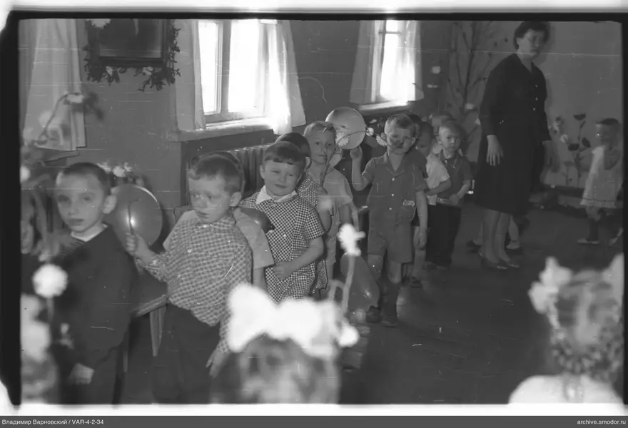 Gruppe von Kindern mit Blumen und Ballons