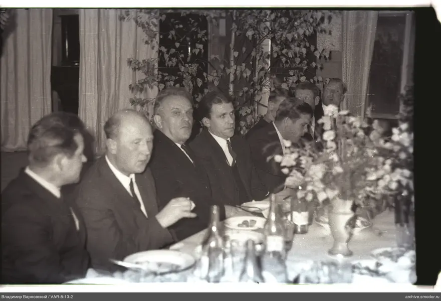 Men sitting at a table during an event