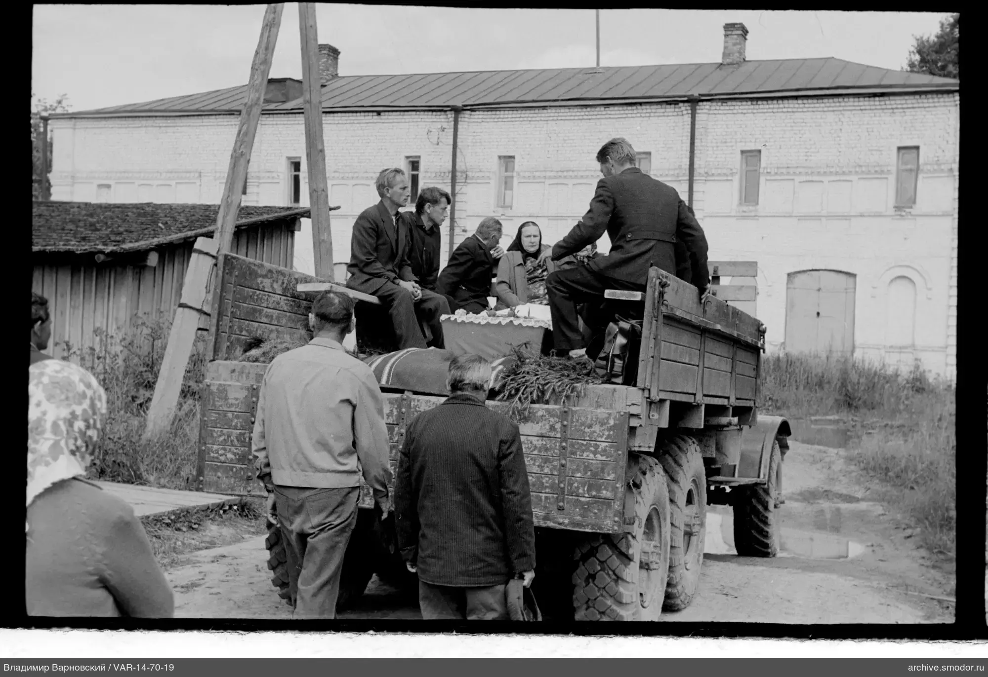 People on cargo truck platform