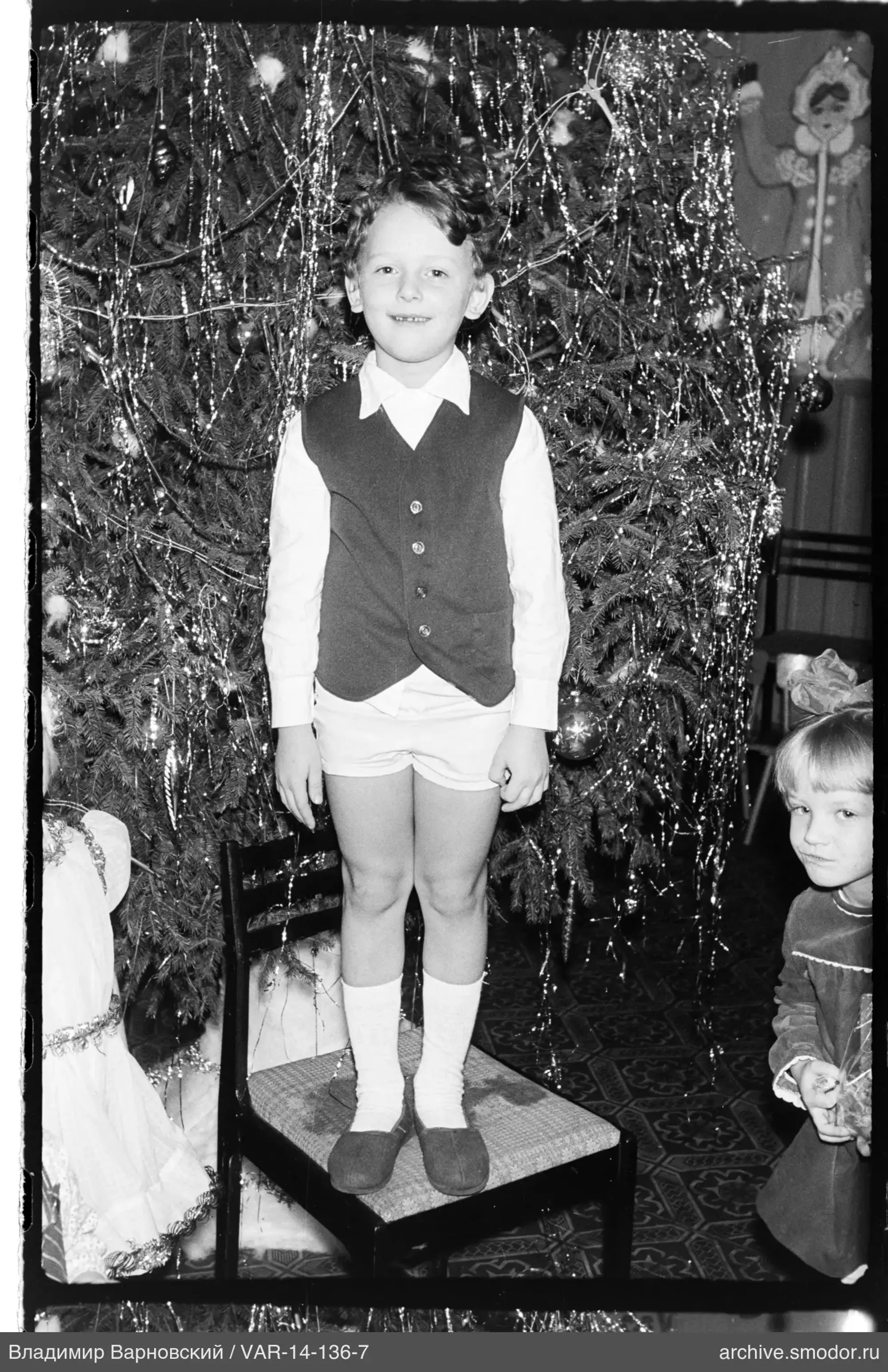Boy in front of decorated Christmas tree