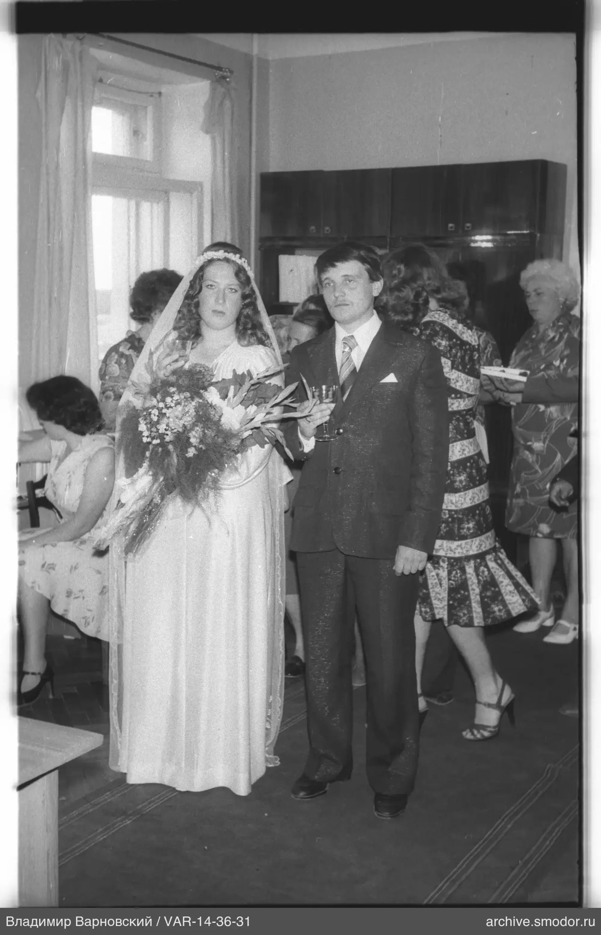 Woman with bouquet and man in suit