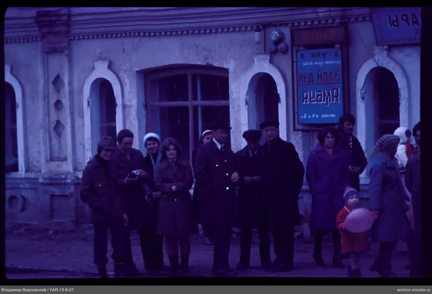 Group of people by building with arched windows