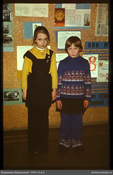 Two girls against an information board