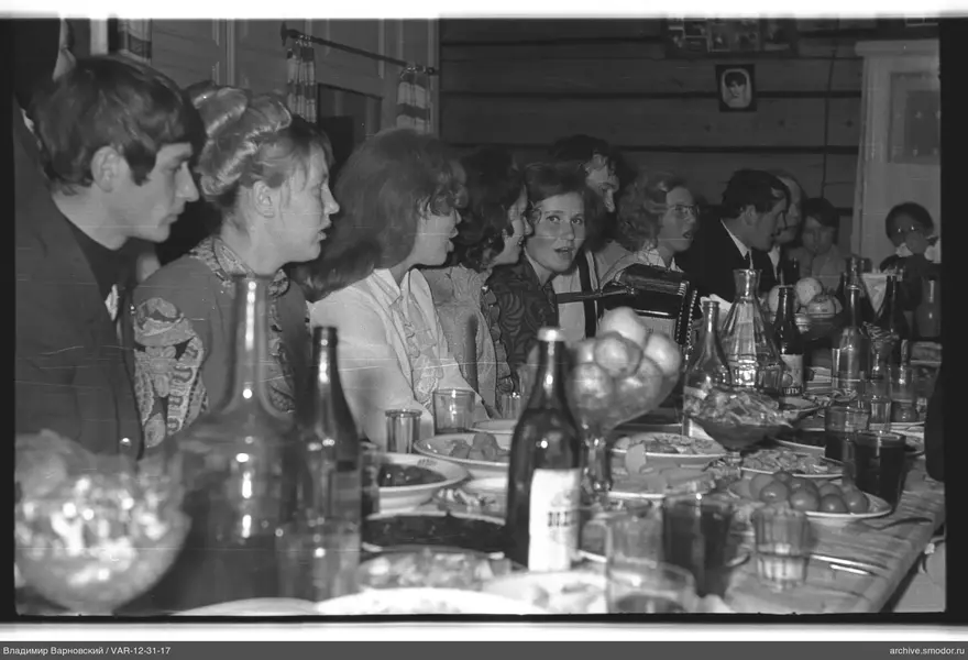 Group at a table with woman playing accordion
