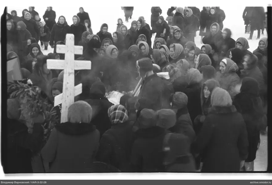 Group of people around a wooden cross