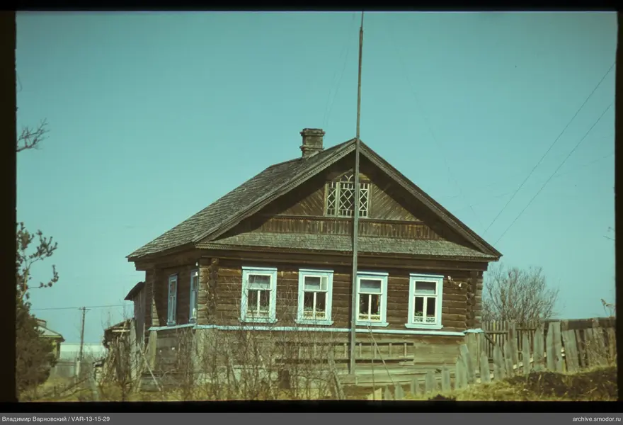 Wooden house with windows and fence