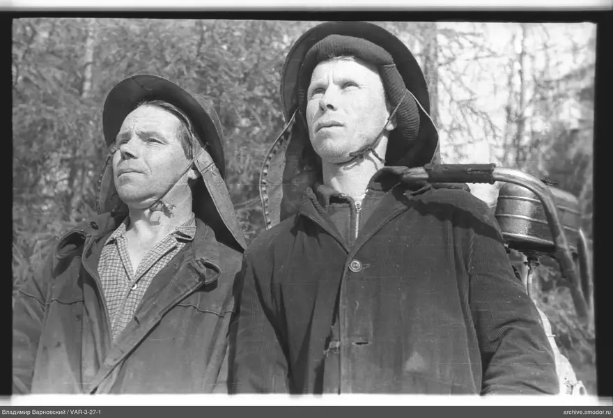 Portrait of two men wearing helmets