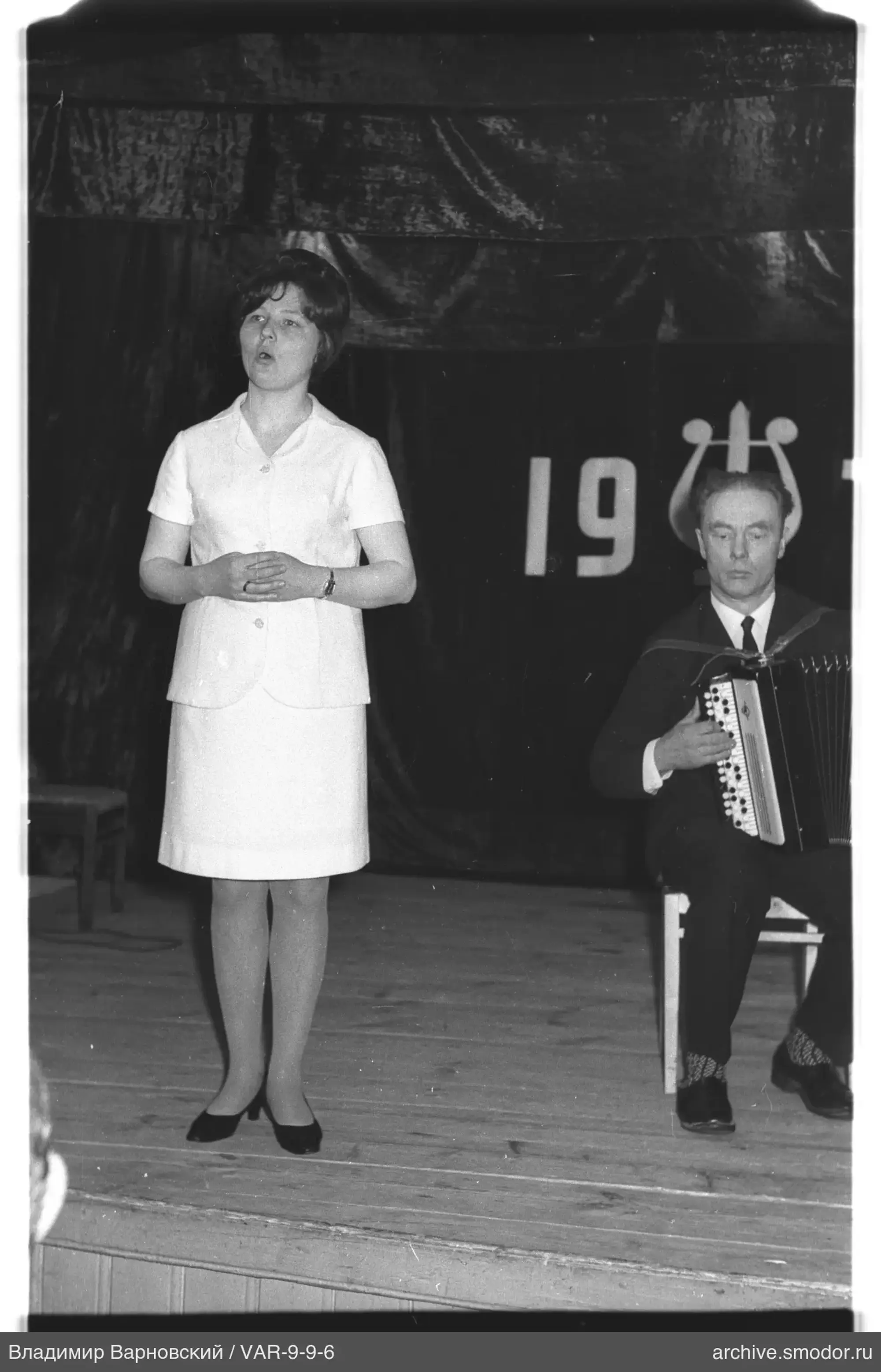 Woman and man with bayan on stage