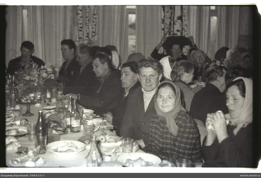 People sitting at a long table at an event