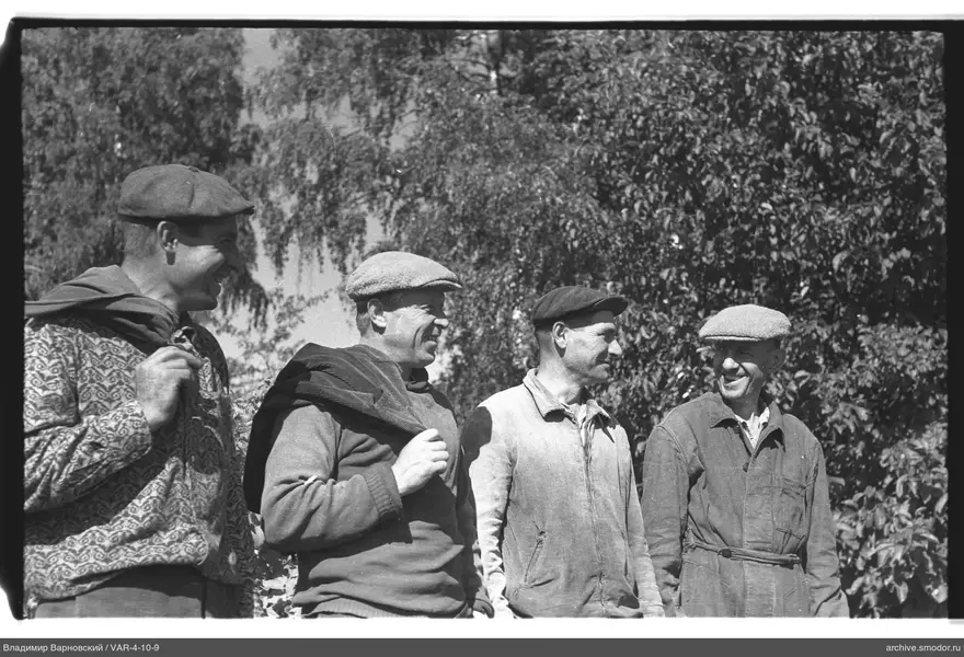 Group of men in caps against trees